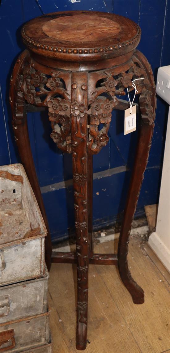 A Chinese carved hardwood marble topped jardiniere stand H.94cm